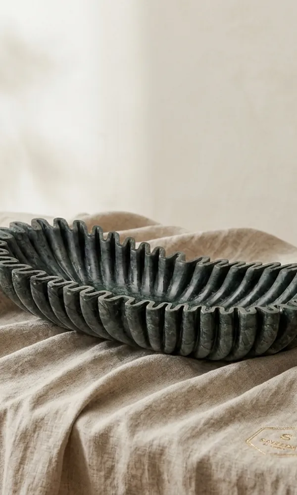 Fluted green marble decorative bowl on linen