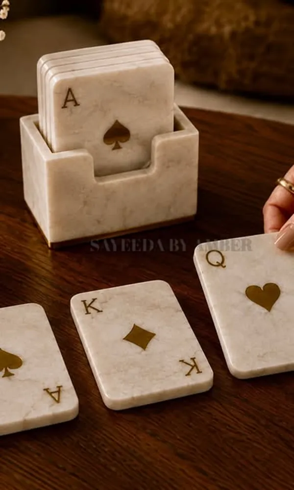Marble card-suit coasters in a marble holder